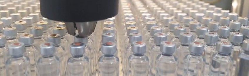 Rows of cartridges in the PleniDose holder, crimped closed — the output the platform exists for